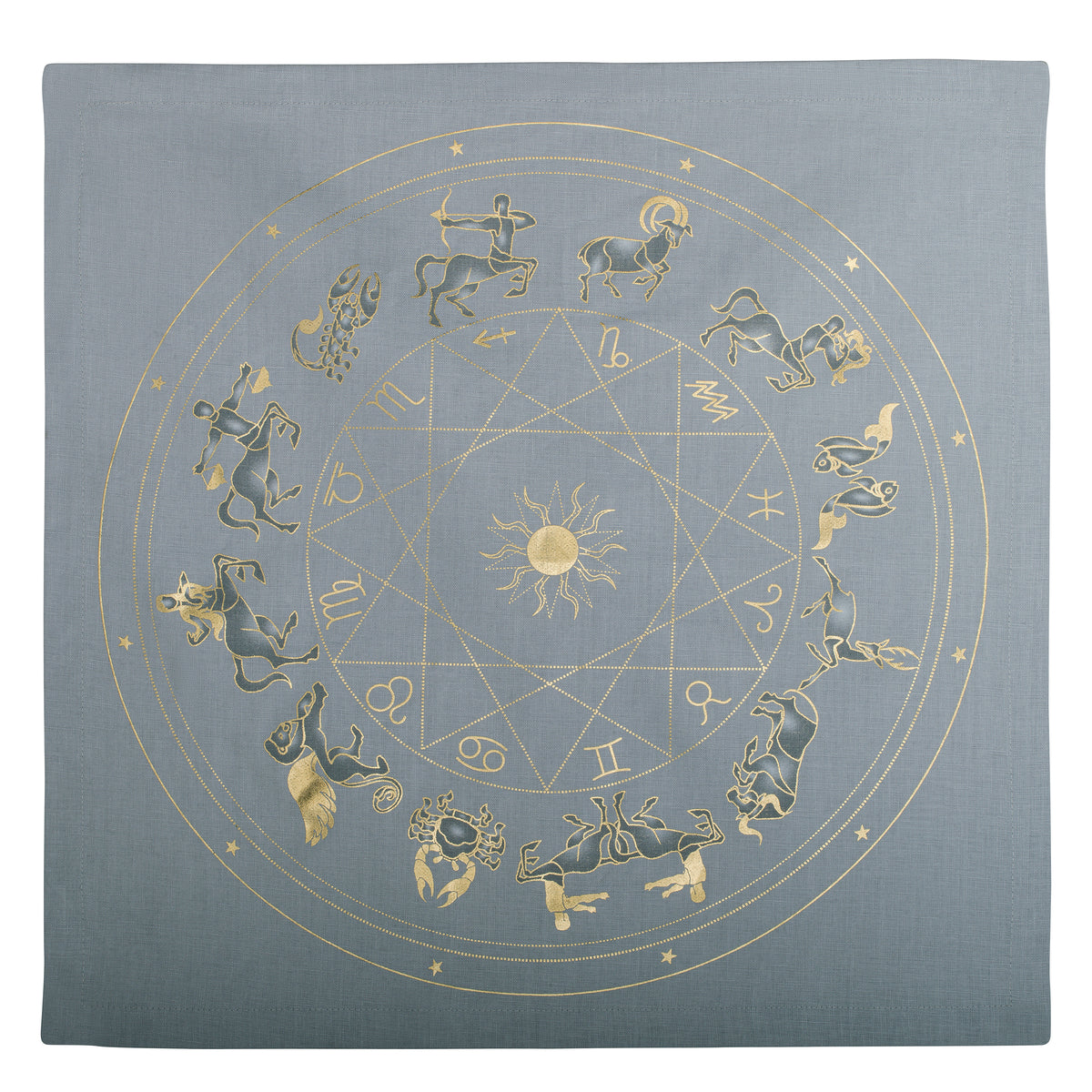 The gold Zodiac wheel on TABLEAU’s gray linen napkin, shown in a close-up